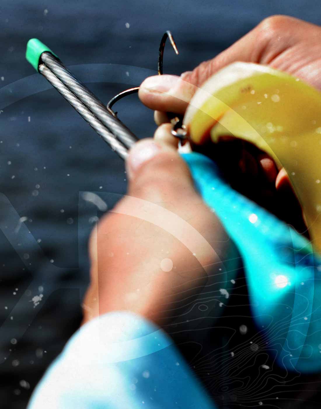Musky angler holding a Stick File Hook sharpener and sharpening a big musky-sized treble hook