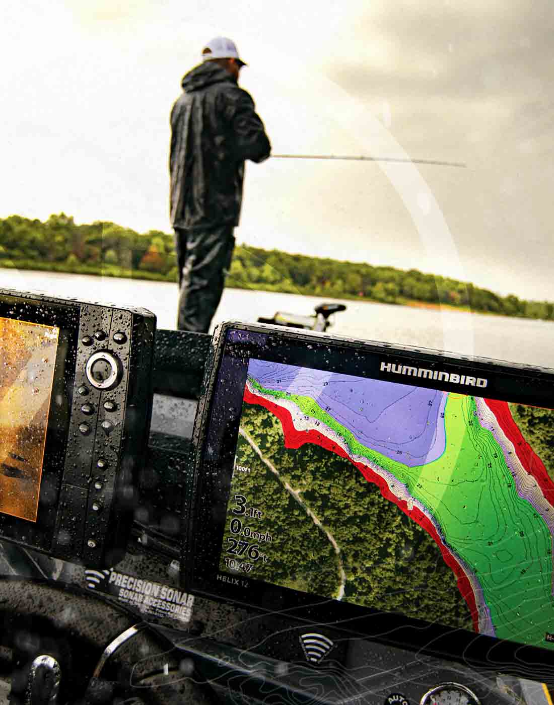 Front view of two humminbird helix rigged on the console of a fishing boat with a fisherman casting on the bow