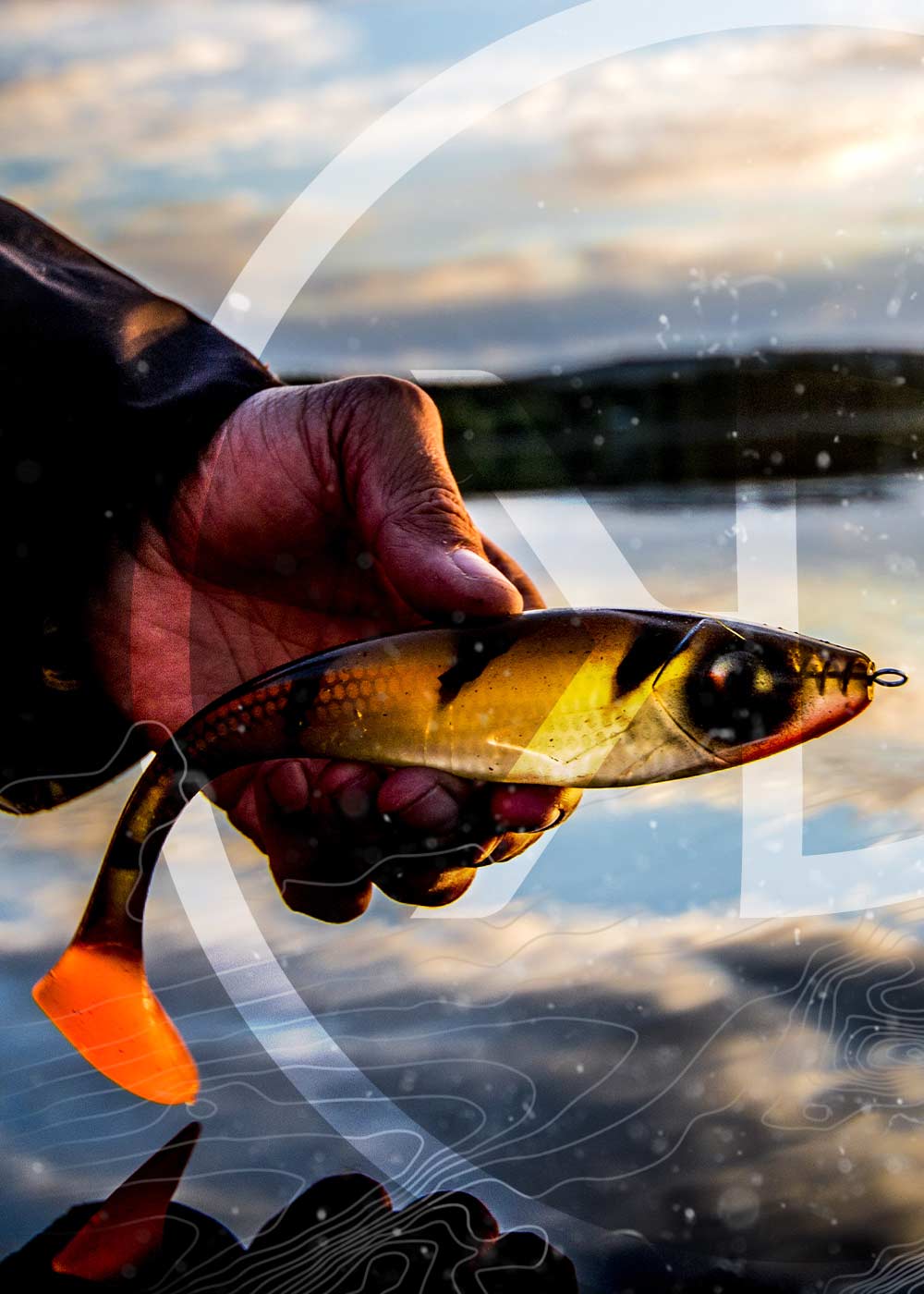 Picture of an angler hand holding a Gator Gum swimbait Lure above the water