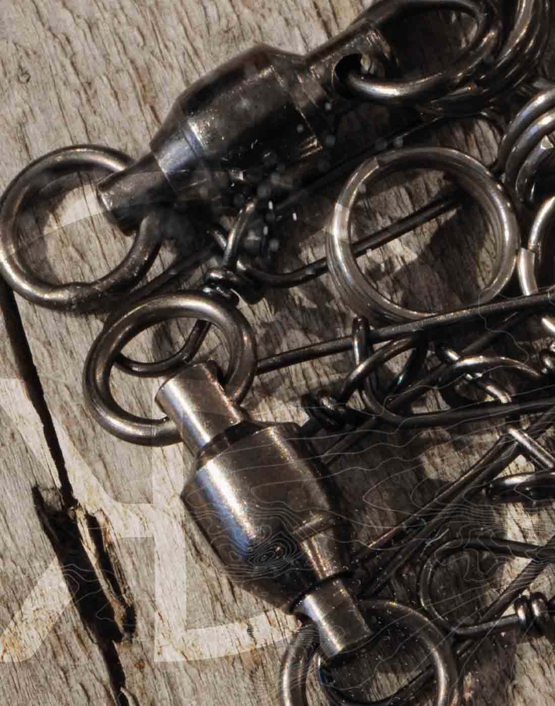 pike & musky staylock snaps, swivels and split rings lying on an old wood table