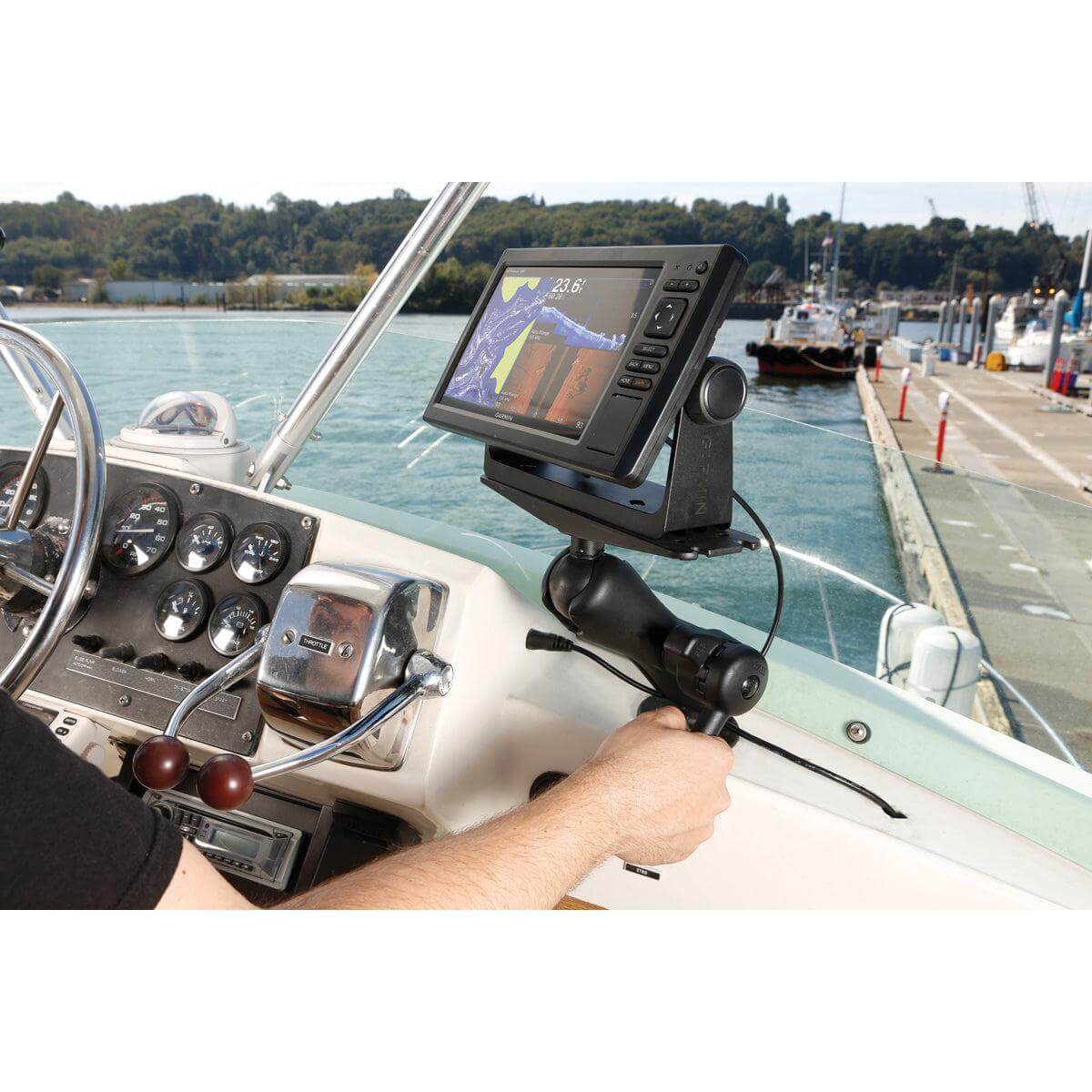 A man on a boat is tightening a RAM mount setup holding a Large Garmin fishfinder using the RAM Hi-Torq Wrench D size