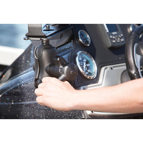 A man on a boat is tightening a RAM mount setup holding a garmin fishfinder using the RAM Hi-Torq Wrench D size